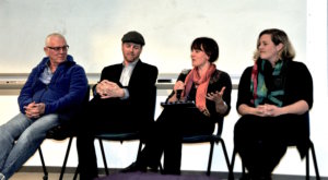 Journalists Chris Joyce, Ed Jahn, Nicola Jones, and Ashley Ahearn sit in chairs before a whiteboard. 