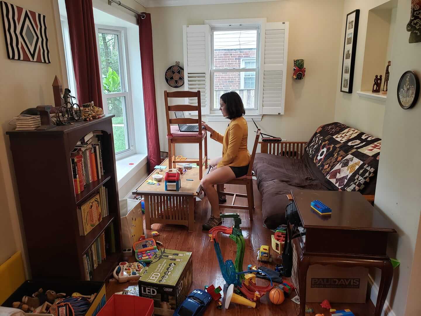 Gretchen Goldman sitting in her living room covered in toys